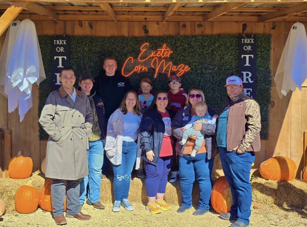 Colby and family together at a fall corn maze.