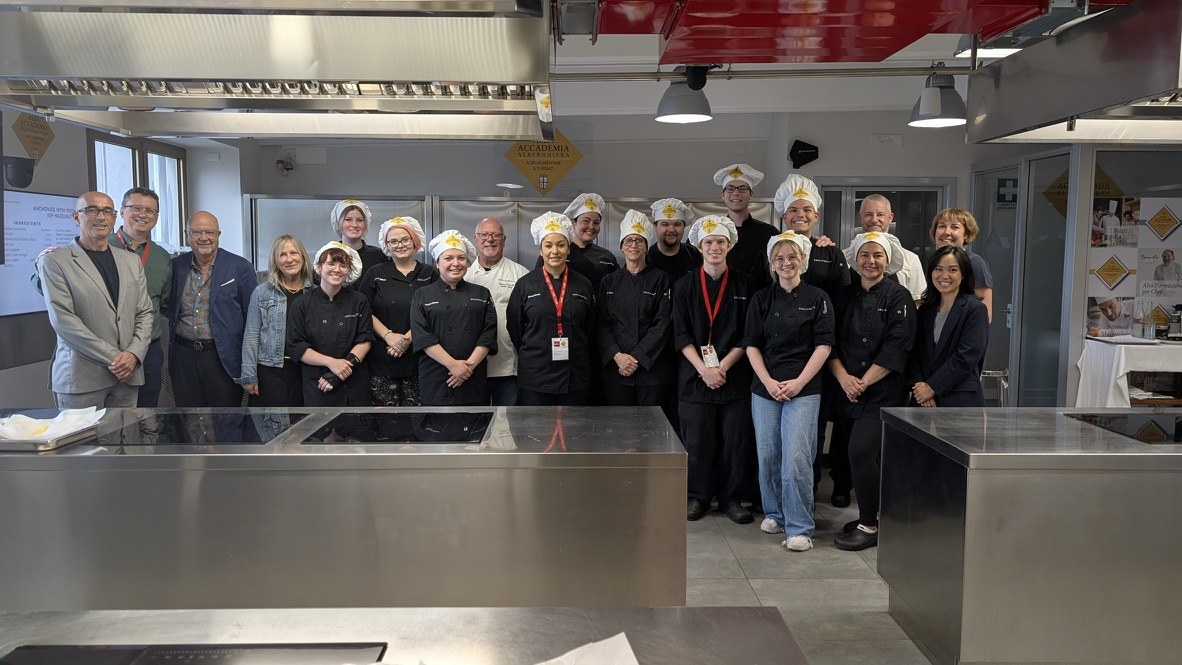 Group photo in the teaching kitchen after completion of the culinary certificate program.
