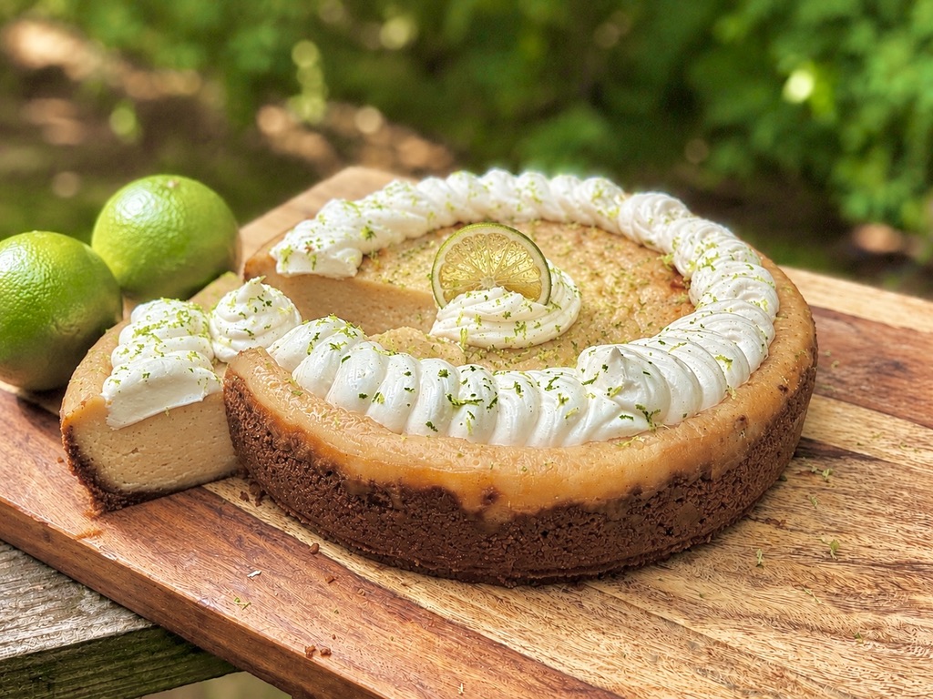 Key lime cheesecake with vanilla bean whipped cream and lime zest