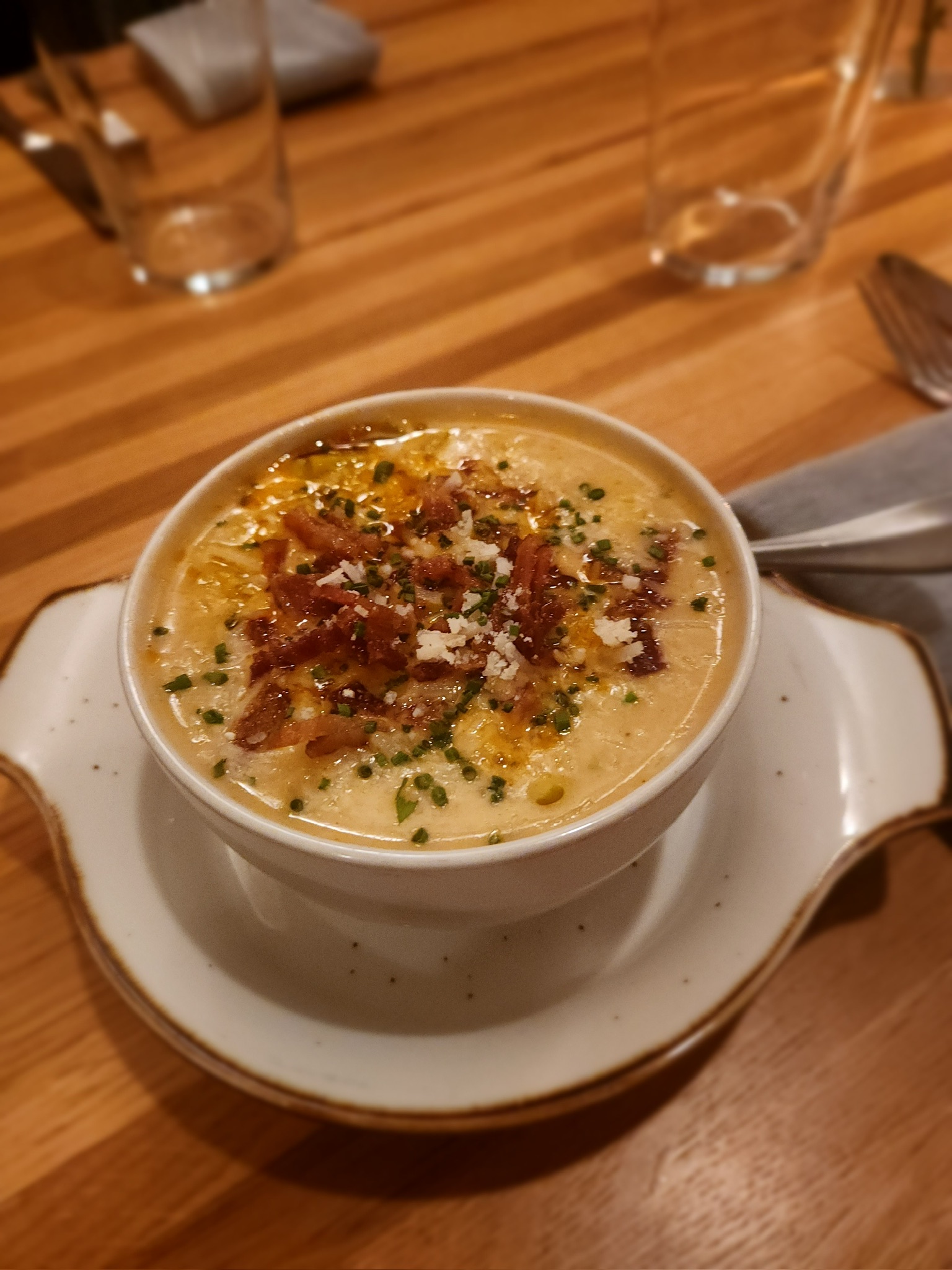 Creamy potato leek soup with chives, cheddar, and bacon