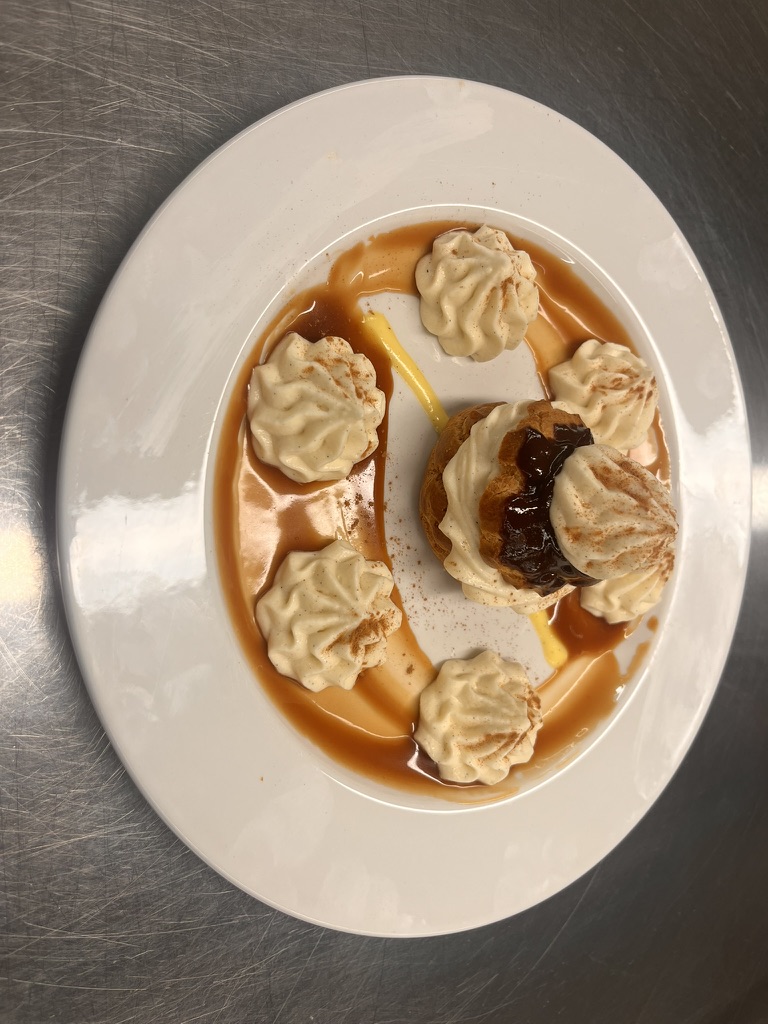 Chocolate-dipped profiterole with Chantilly cream and caramel