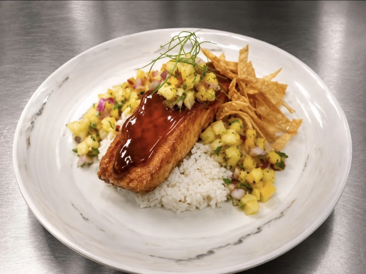 Teriyaki-glazed salmon served over steamed rice with pineapple salsa and crispy wontons.